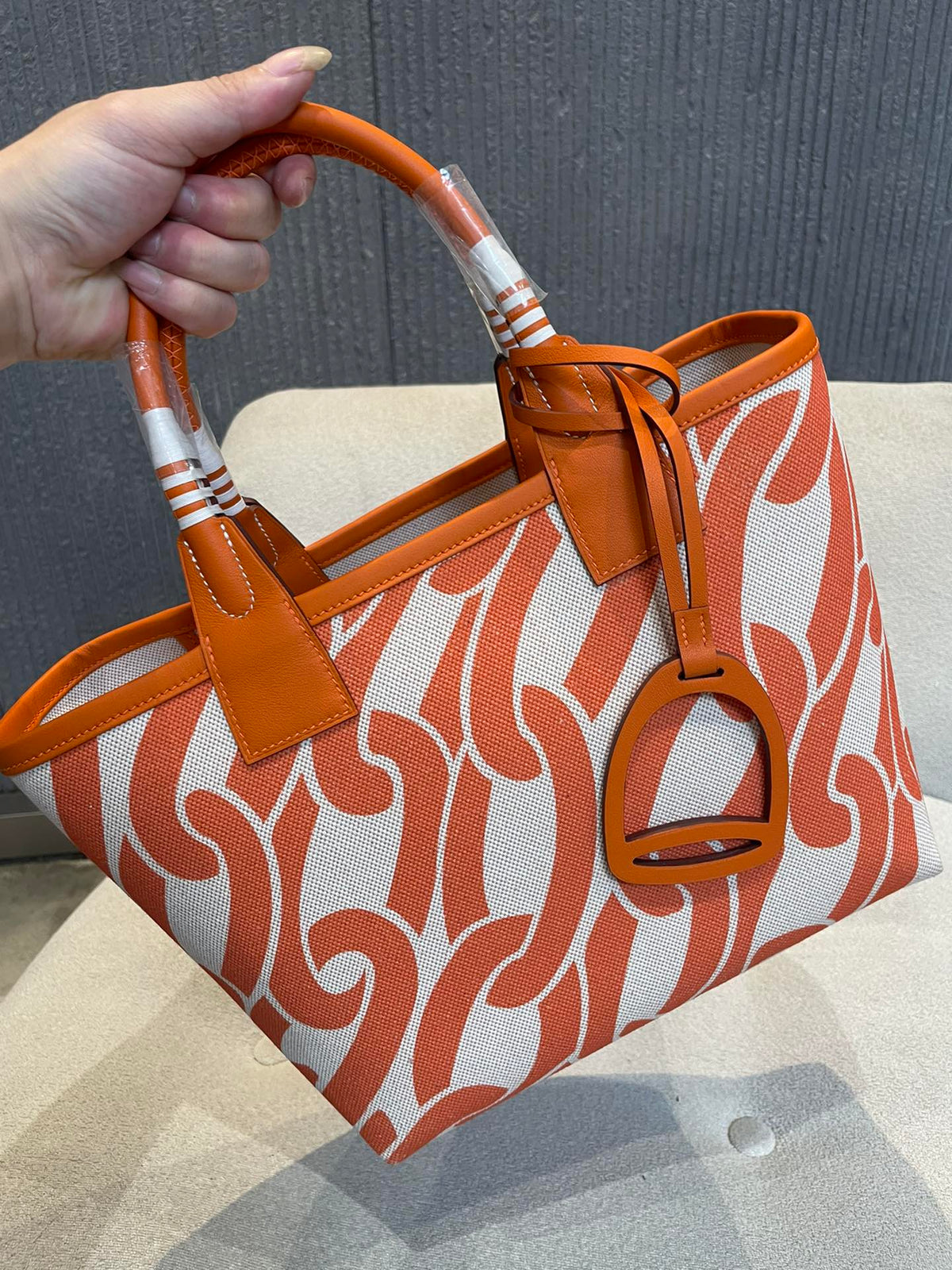 Orange Chain Link Pattern Canvas Tote Bag with Leather Top Handles and Stirrup Charm